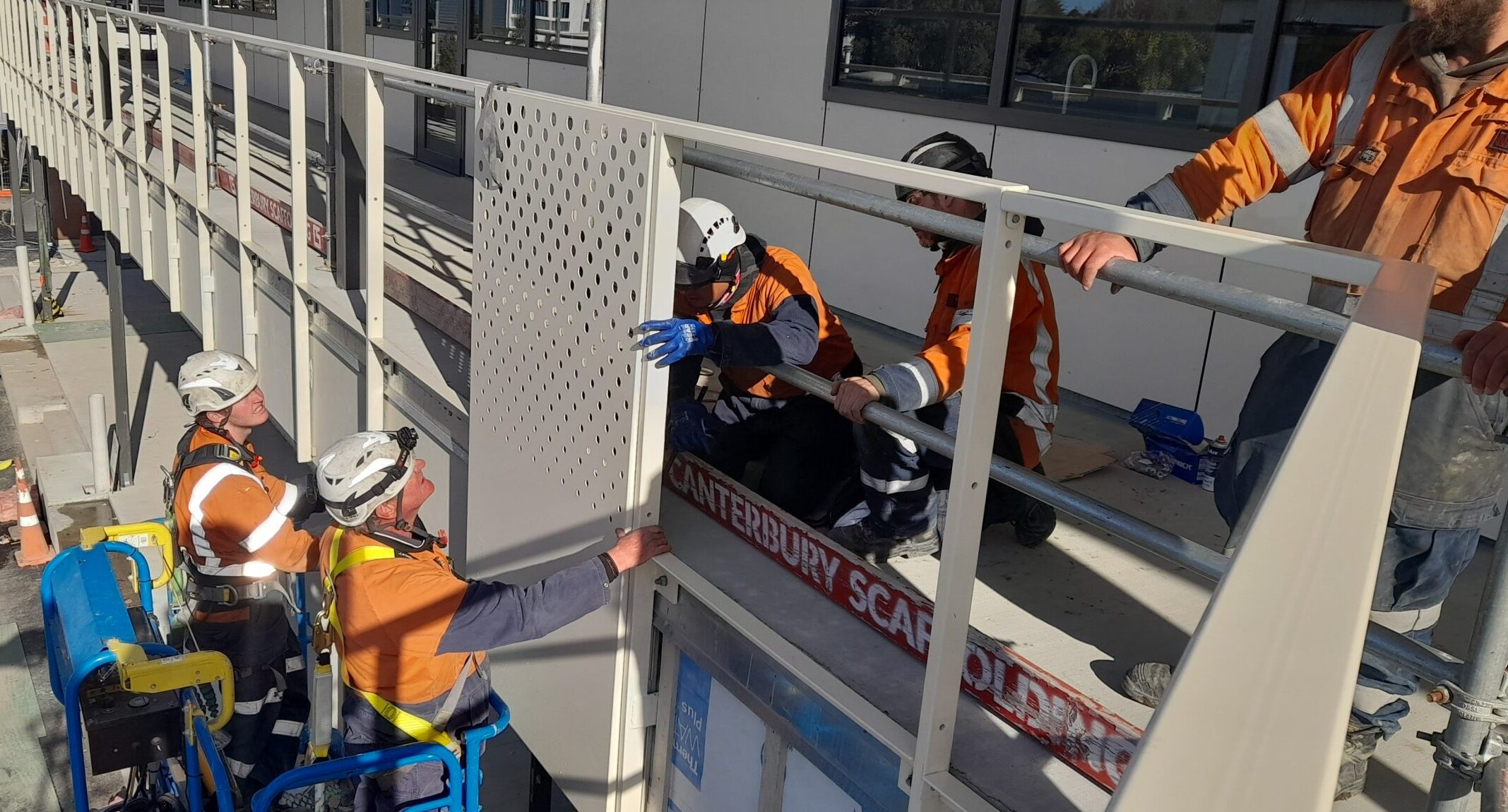 workmen inserting aluminum pieced into balustrade