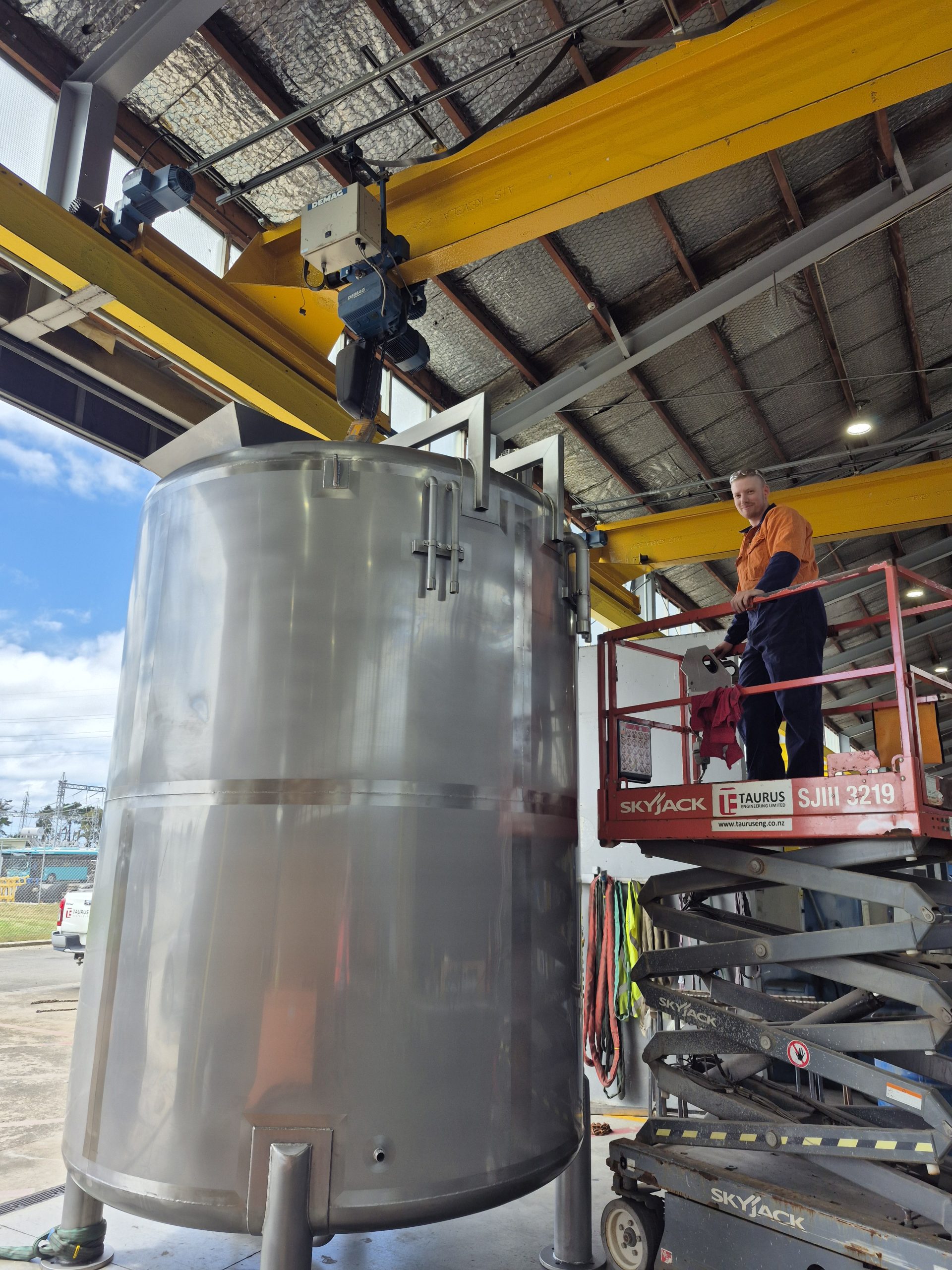 mixing tank on crane in workshop